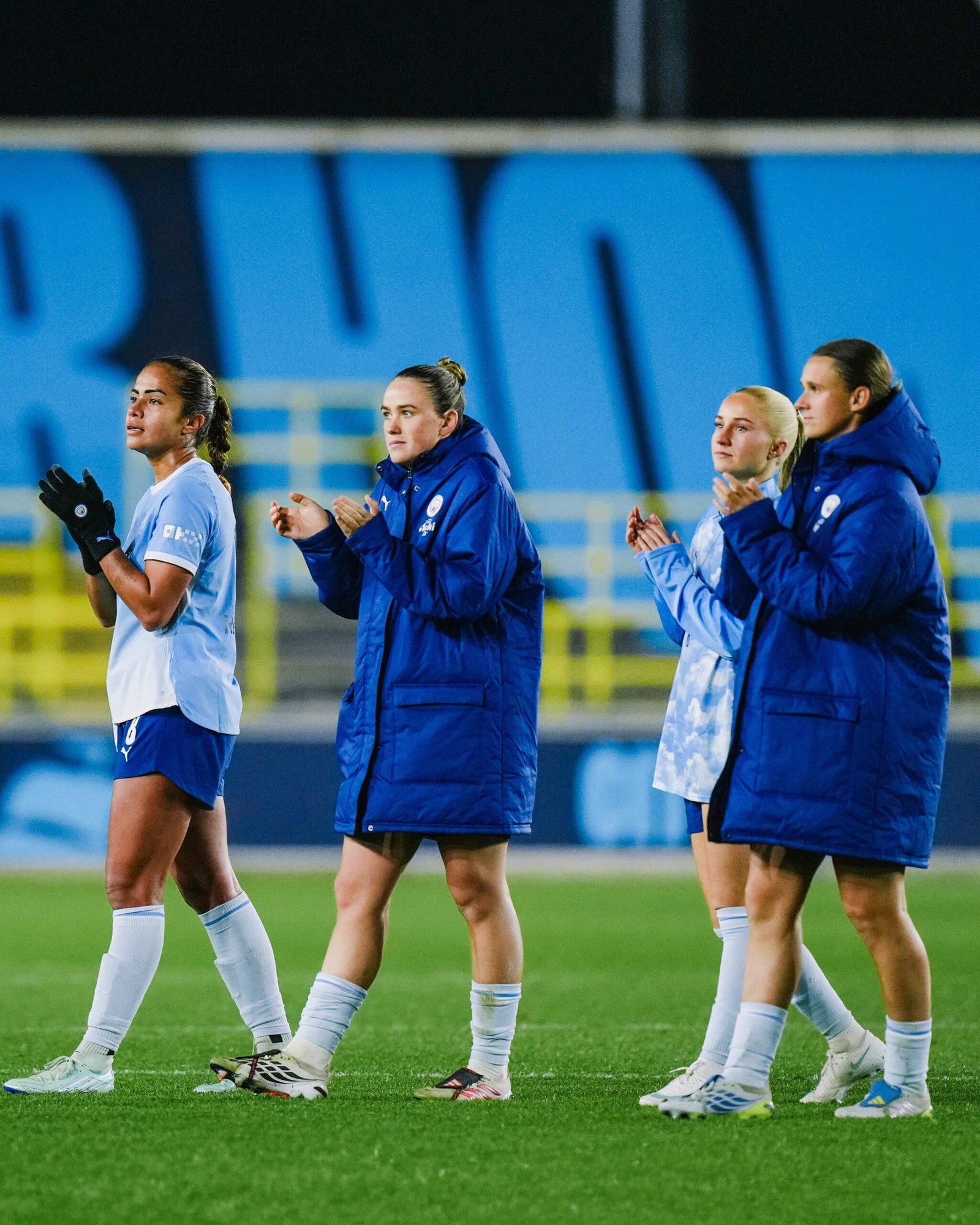 Man City Women players applaud supporters after the PSG draw