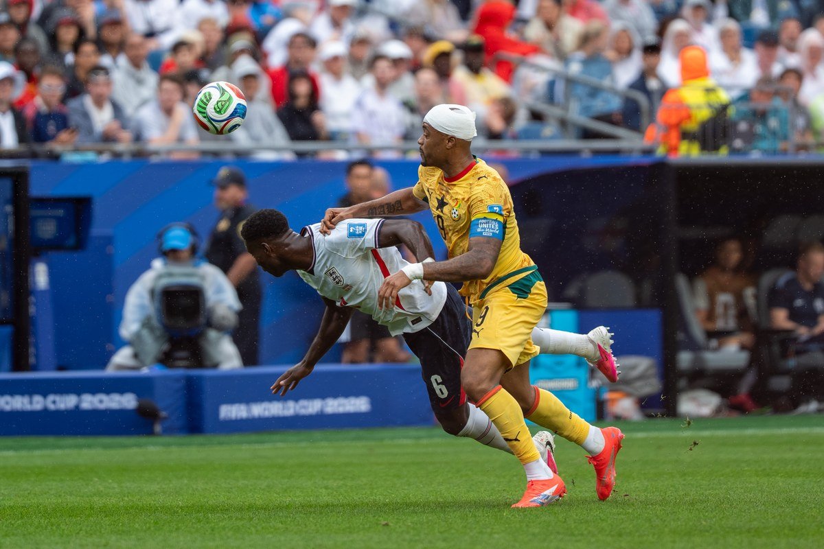 Marc Guehi challenges Jordan Ayew for the ball during England v Ghana at the 2026 World Cup